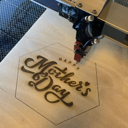 What materials can be engraved or cut with a laser etching machine?